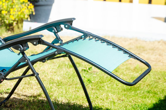 Blue Sunbed Deck Chair In Garden