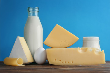 Set of fresh dairy products on color background