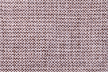 Light brown textile background with checkered pattern, closeup. Structure of the fabric macro.