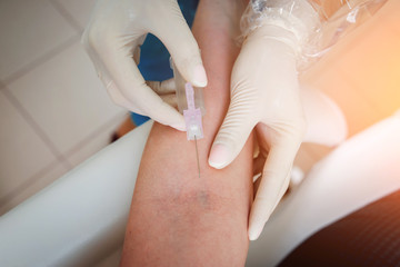 Closeup of nurse's hands taking a blood sample
