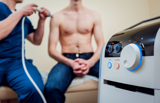 Shock Wave Therapy. The Magnetic Field, Rehabilitation. Physiotherapist Doctor Performs Surgery On A Patient's Shoulder