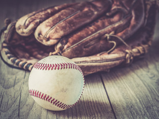 Old baseball ball on wooden background and highly closeup