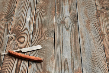 Vintage barber shop straight razor tool on wooden background