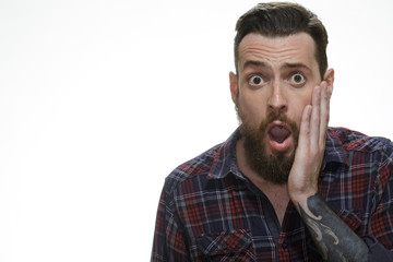 No way! Portrait of a surprised bearded man looking to the camera copyspace on the side isolated on white.