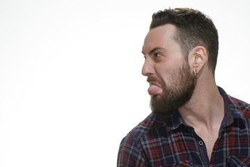 Obraz premium Why too serious? Shot of a bearded man looking at the copyspace sticking his tongue out at the studio isolated on white.