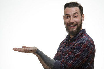 The best choice. Studio shot a cheerful bearded man looking to the camera laughing holding copyspace on his hands on white background.