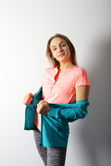Young fitness woman in sportswear indoor