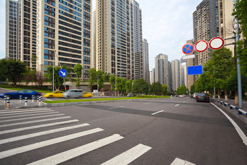Fototapeta premium Empty road surface floor with City streetscape buildings