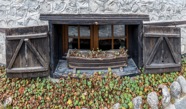Ancient window with wooden shutters in the wall of the house in the Old town - Bansko, Bulgaria