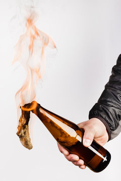 Glass bottle, the so-called Molotov cocktail in the hand of the activist. Isolated on a white background.