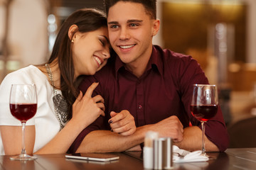 Affectionate loving couple cuddling on a restaurant date
