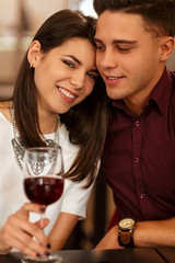 Affectionate loving couple cuddling on a restaurant date