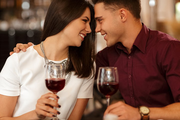 Affectionate loving couple cuddling on a restaurant date