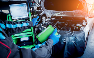 Professional car mechanic working in auto repair service.