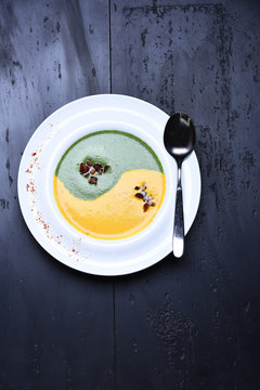 spinach and pumpkin cream soup or puree with silver spoon