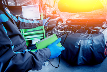 Professional car mechanic working in auto repair service.