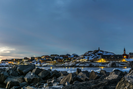 Nuuk city old harbor sunset view with stones and icebergs, Greenland