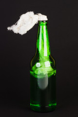 Glass bottle filled with gasoline, the so-called Molotov cocktail, isolated on black background.