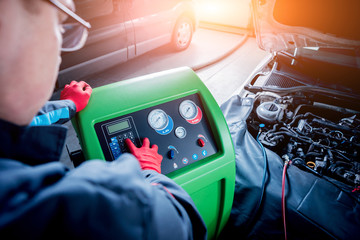 Servicing car air conditioner. Service station.