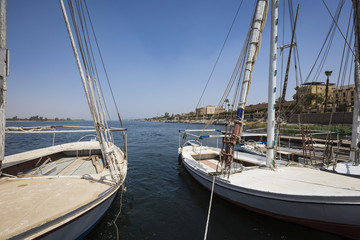 Fototapeta na wymiar Wooden boats felucca at the Nile River in Aswan, Egypt, North Africa