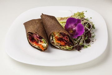 Tortilla wrap or burrito with tofu greens and vegetables vegetarian healthy food with sprouts and lettuce