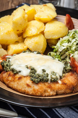 Fried chicken fillet with spinach and cheese.