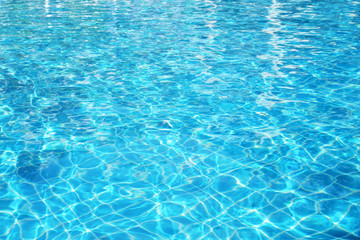 Blue pool water with sun reflections