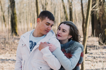 Obraz premium Happy couple in love hugging and sharing emotions, holding hands walking in the park