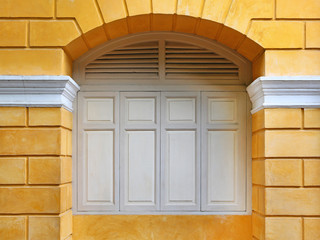 Yellow wall with close windows, Europe style