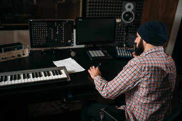Sound producer work with audio equipment in studio