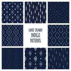 Set of hand drawn indigo blue patterns. Seamless vector aztec backgrounds with triangles, arrows, rhombuses and diamonds.