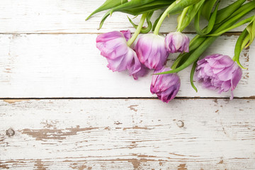 Naklejka na ściany i meble beautiful tulips on wooden background. Top view