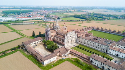 Fototapeta na wymiar Vista aerea della Certosa di Pavia, costruita alla fine del XIV secolo, campi e chiostro del monastero e santuario in provincia di Pavia, Lombardia, Italia