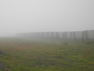 Abandoned fence in the fog