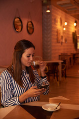 Tea sipping millenial in a restaurant