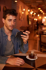 Attractive millenial reading a message on phone