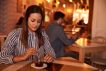 Stunning millenial sitting alone in restaurant