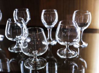 Clean alcohol glasses on wooden shelf