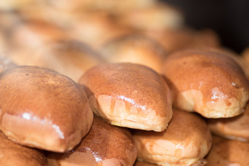 Oven fresh home made baked patties. Delicious pastries on a baking sheet. Russian pirozhki (baked patties). Traditional russian pies, good food for holiday