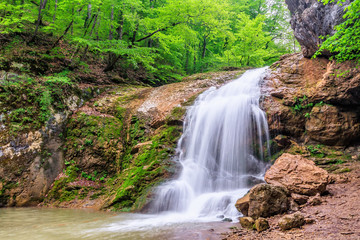 Beautiful scenic landscape of Rufabgo waterfall in green Caucasus mountain forest at spring © Wilding