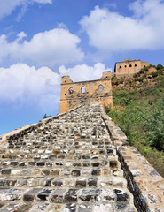 Fototapeta na wymiar Cobblestone path up to a watchtower at Jinshanling Great Wall