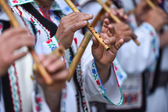 People singing at traditional wooden flutes