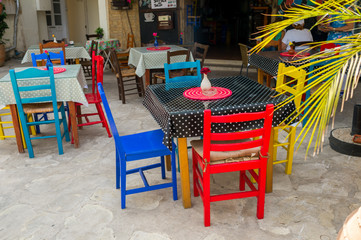 colored multi-colored tables chairs in cafe
