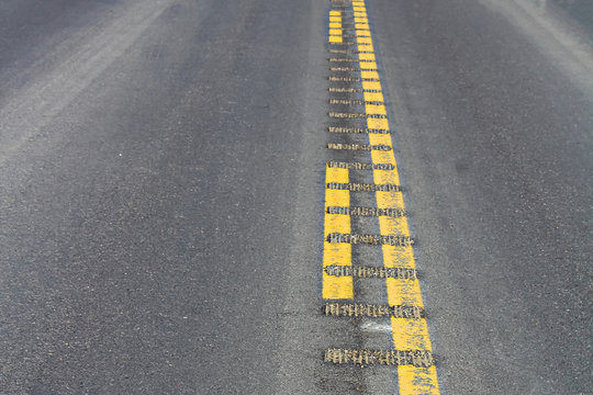 Closeup view of center rumble strips on a highway