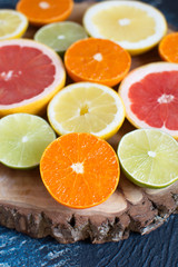 Cut citrus fruits on the dark blue background