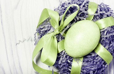 Easter composition on light wooden background. Toned