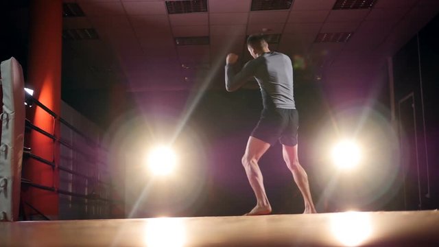 Mixed martial arts fighter shadow boxing in preparation for a fight. Medium shot. HD