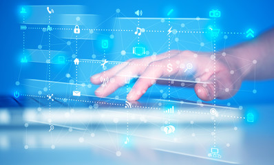 Hand pressing keyboard with high tech media icons