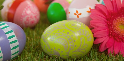 Painted easter eggs with flower on grass
