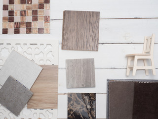 samples of material, wood , color, on wooden table.Interior design select material for idea.